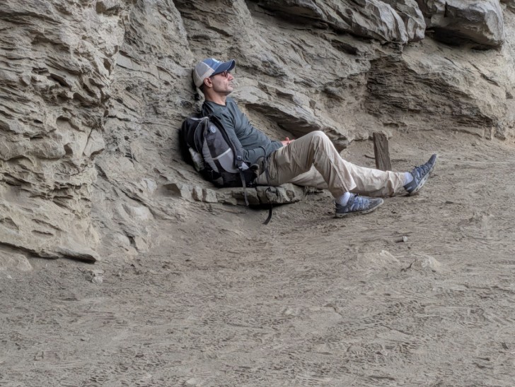 Resting against a rock formation
