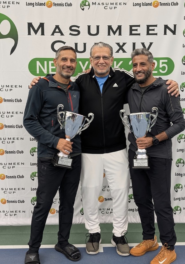 Holding the Masumeen Cup trophy with teammates