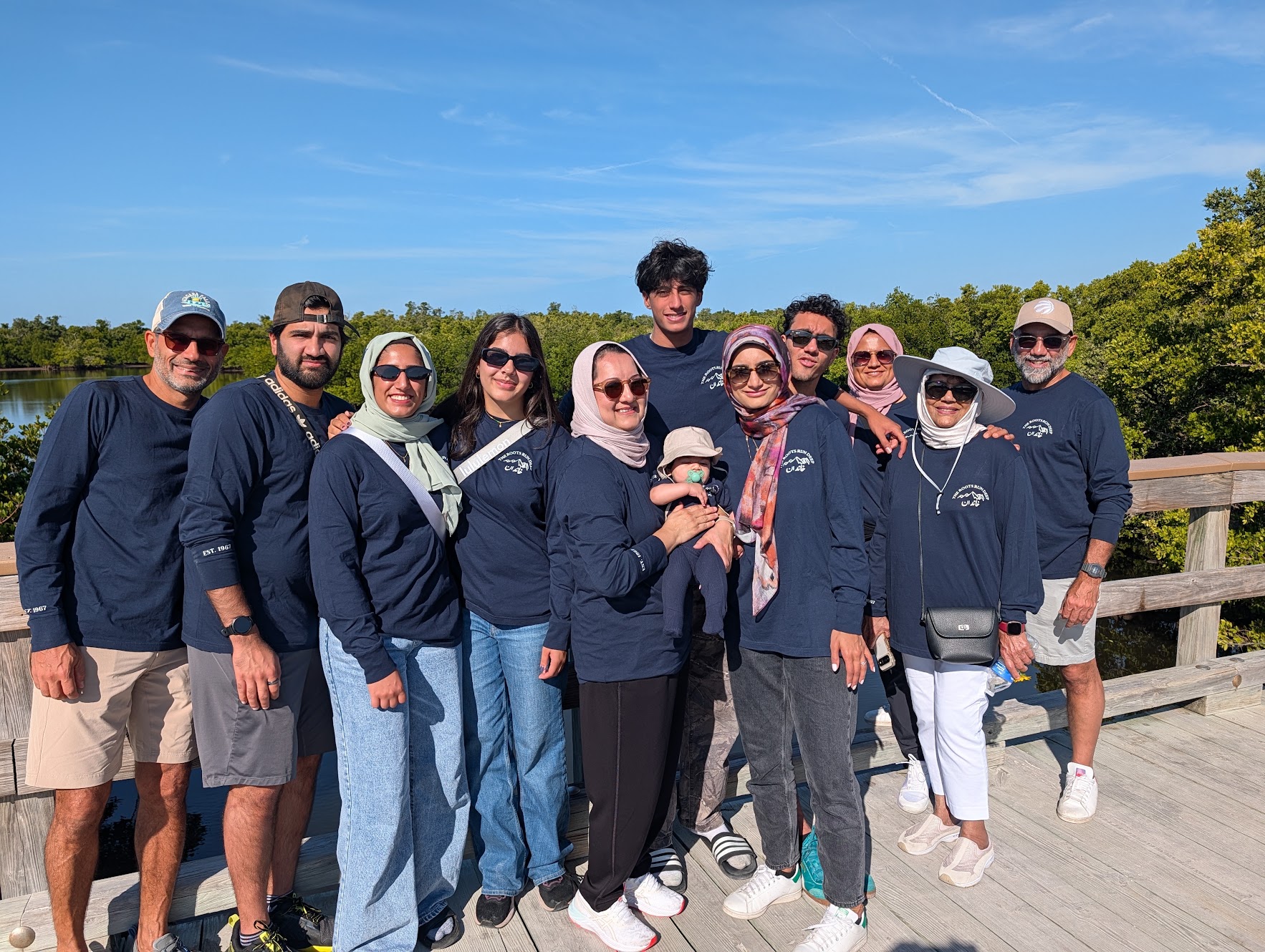 Group photo at the beach in matching SMASH 2025 hoodies